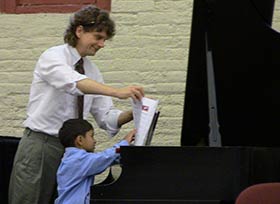 My students and I have fun performing together. Me with a student at a recent recital performance.